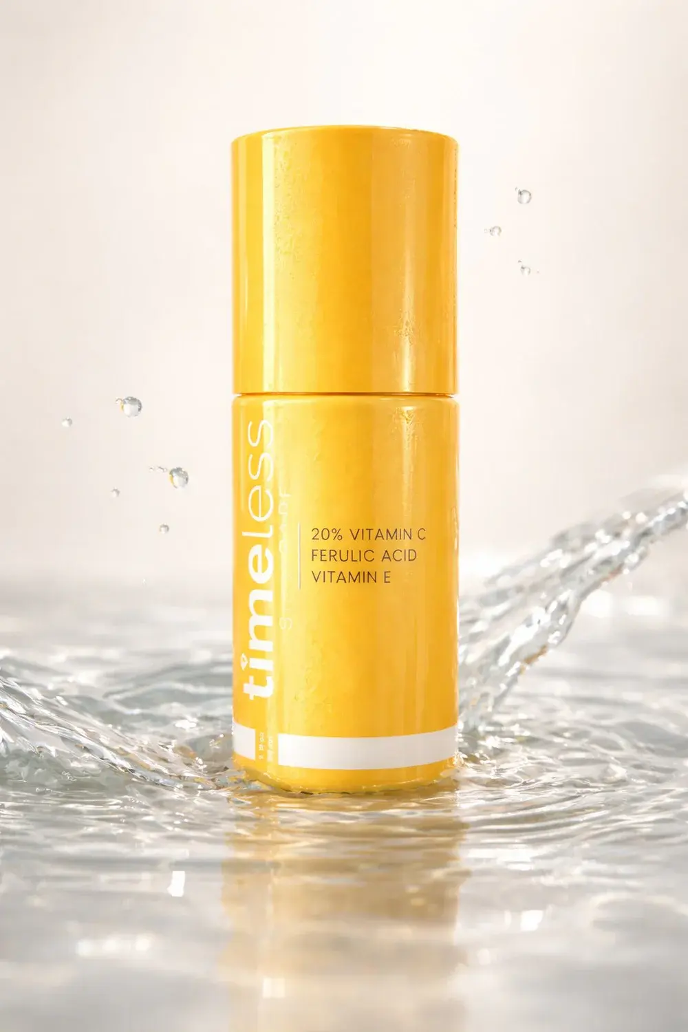 Yellow vitamin C skincare bottle standing in splashing water